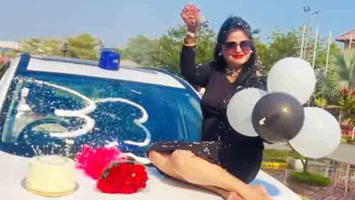 DSP wife sitting on the bonnet of a blu light car,fork cake,fir lodged